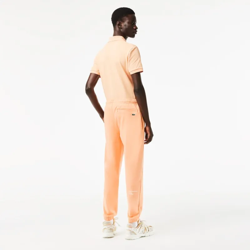 PANTALON DE SURVÊTEMENT HOMME COUPE FUSELÉE INSCRPITION LACOSTE ORANGE